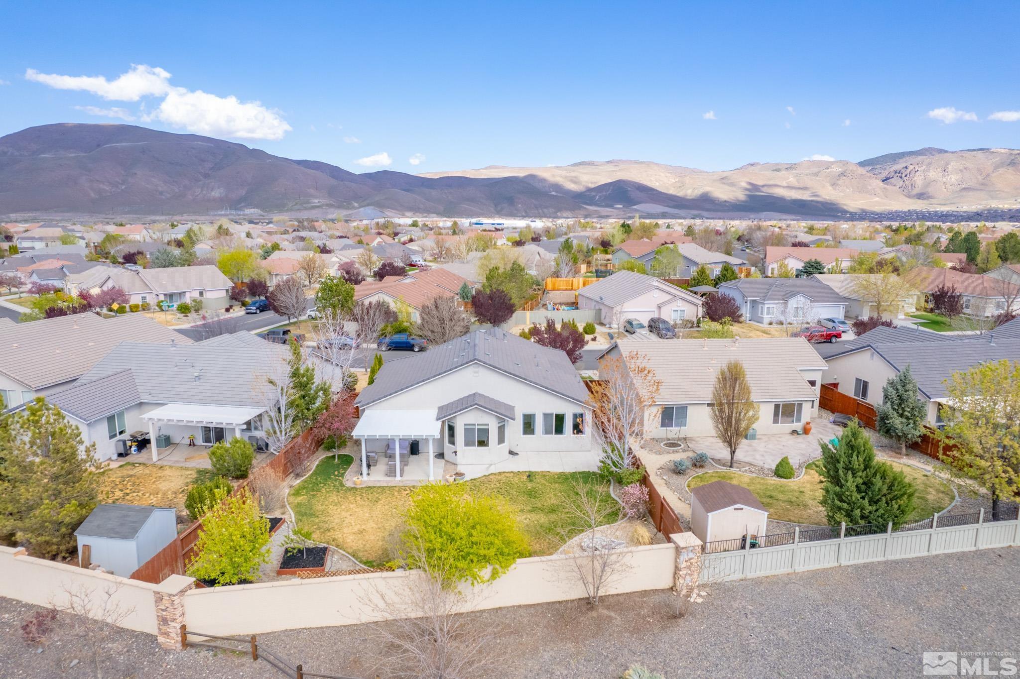 1625 Canyonlands Way Reno, NV 89521 - Photo 30 of 31 a view of a house with a swimming pool and a yard