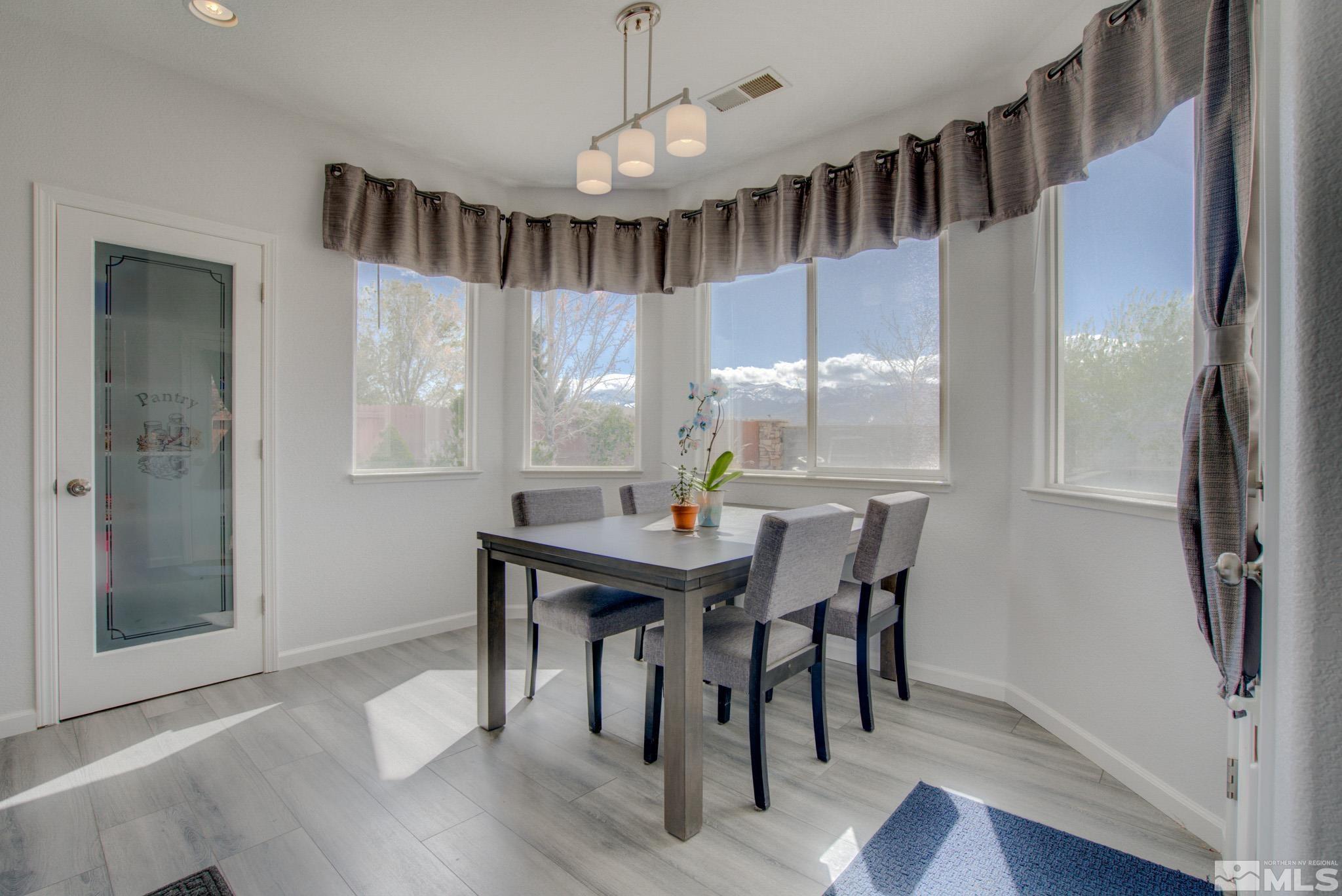 1625 Canyonlands Way Reno, NV 89521 - Photo 7 of 31 a view of a dining room with furniture window and wooden floor