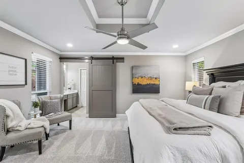 a bedroom with a bed and a couch