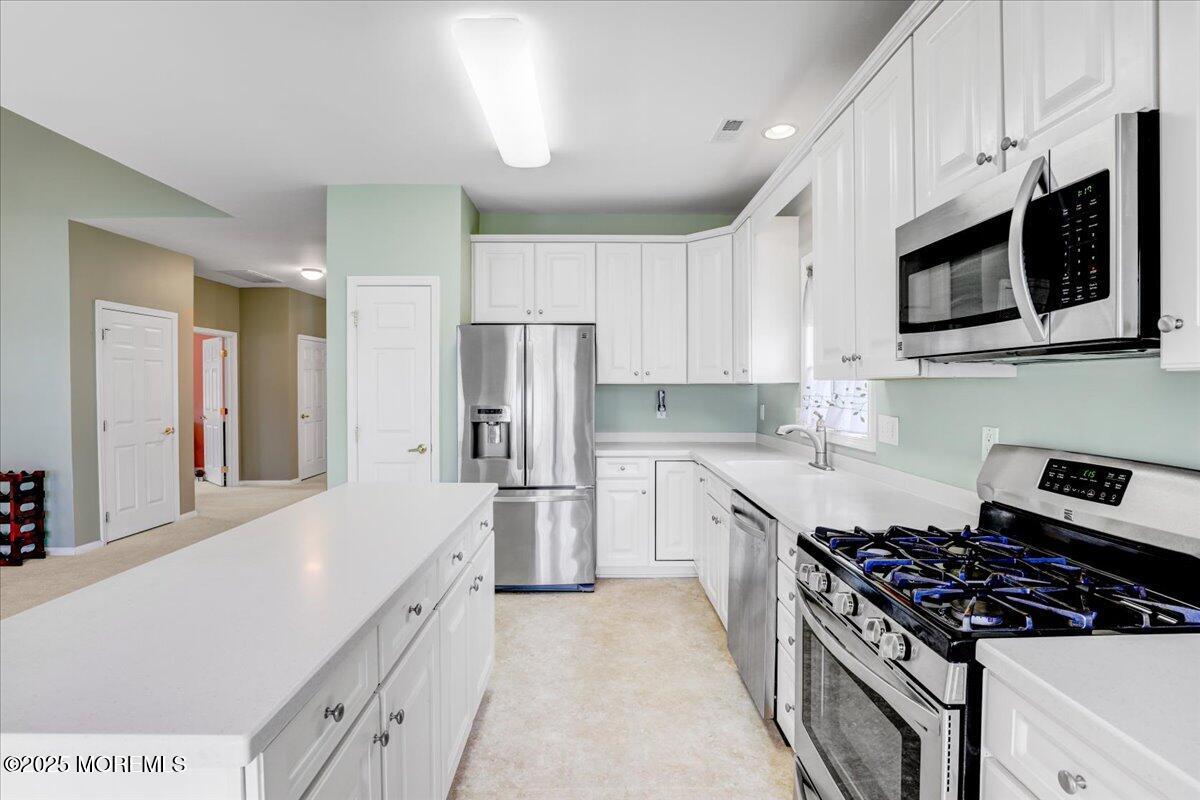 4 Long Bay Road Jackson, NJ 08527 - Photo 14 of 48 a kitchen with stainless steel appliances a stove a sink and a microwave