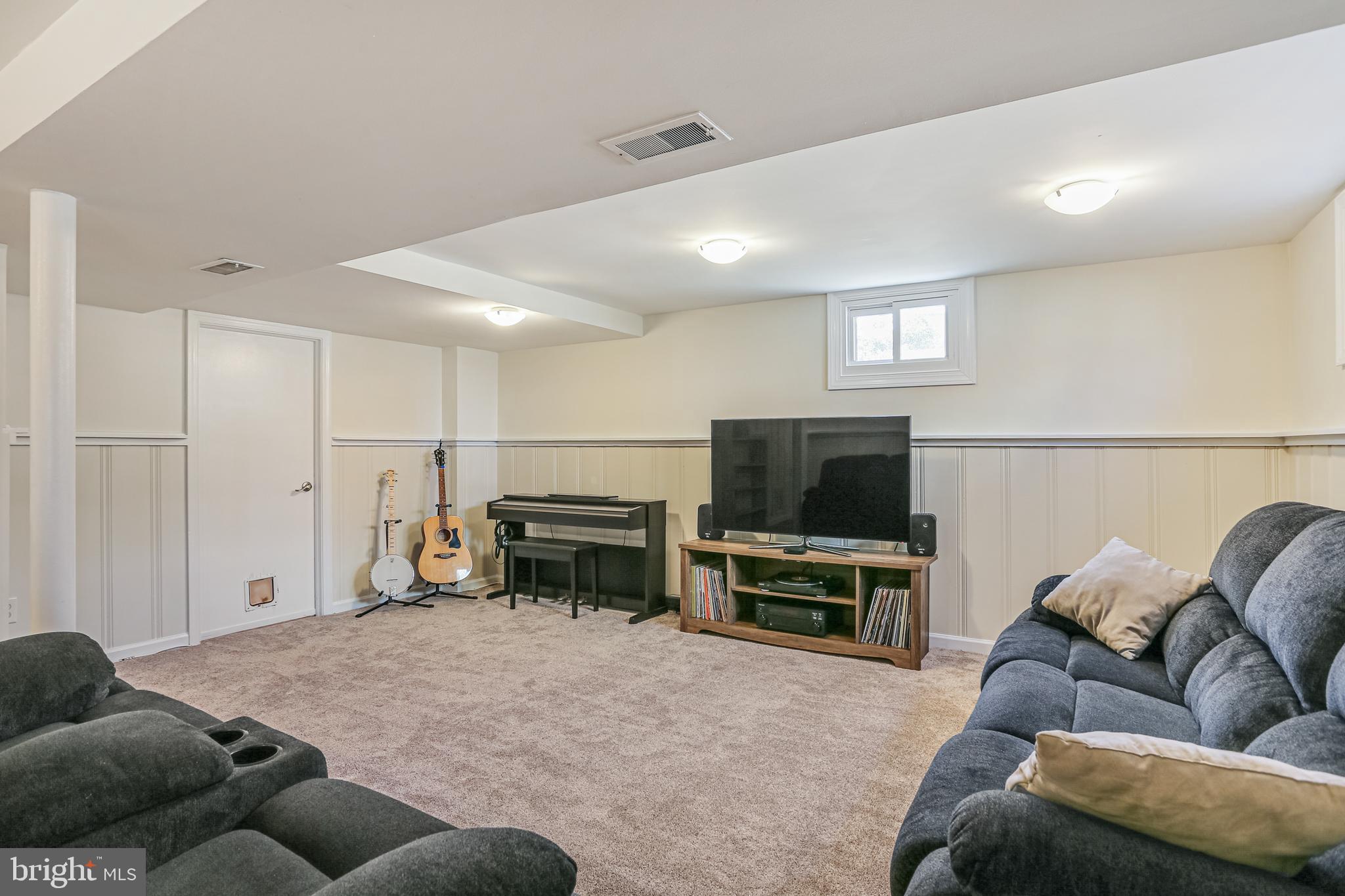 12702 Goodhill Road Silver Spring, MD 20906 - Photo 23 of 28 a living room with furniture and a flat screen tv