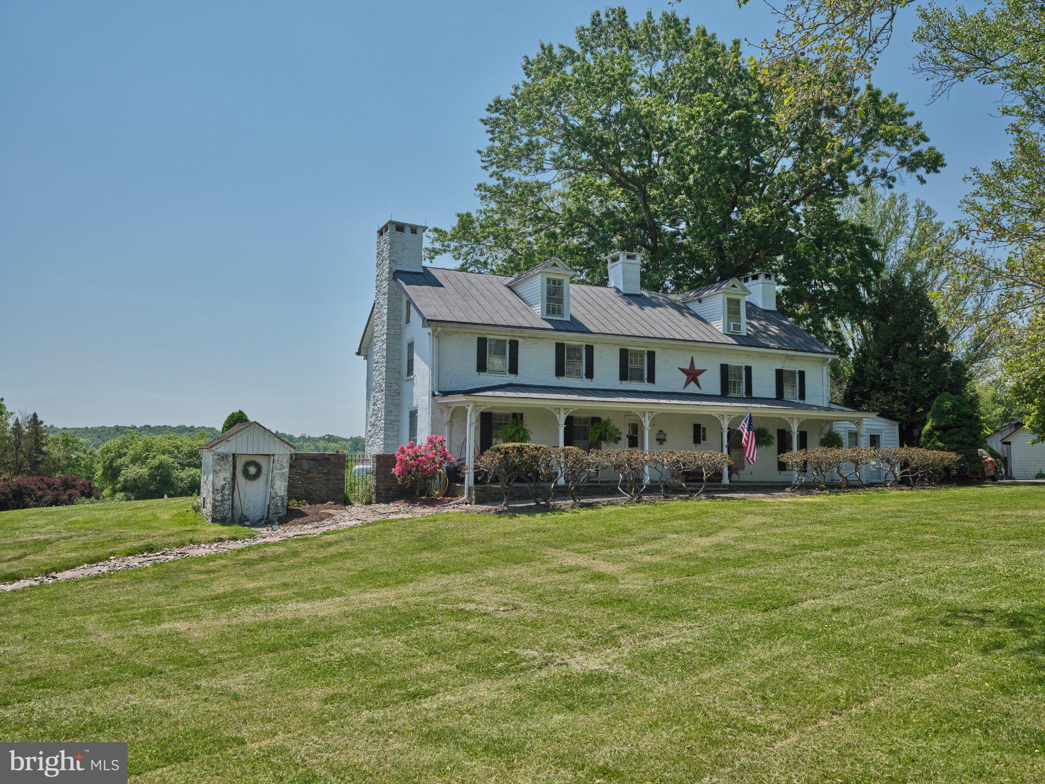 765 Swamp Road Newtown, PA 18940 - Photo 2 of 37 a view of a house with a big yard and large trees