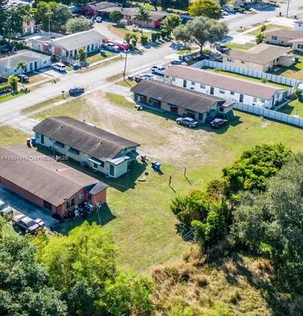 an aerial view of residential houses with outdoor space