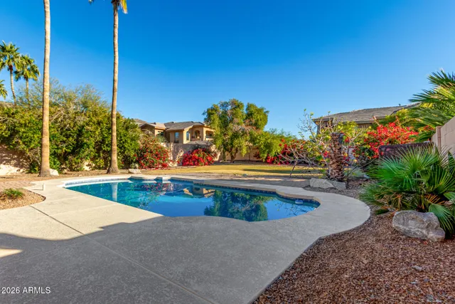 a swimming pool with outdoor seating and yard