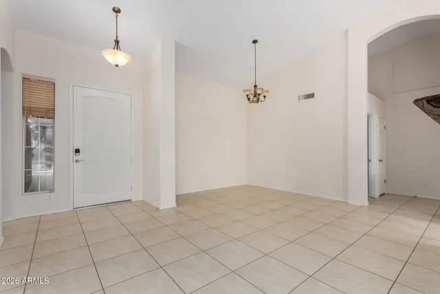 a view of an empty room and window ceiling fan