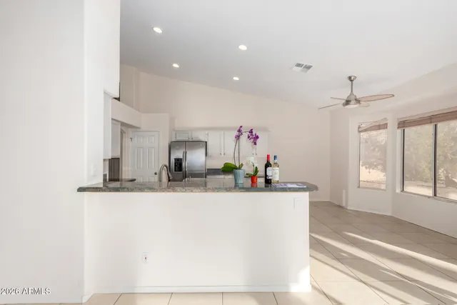 an empty room with closet and a ceiling fan