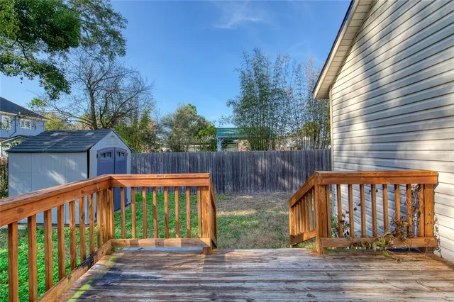 a view of a wooden house with a yard