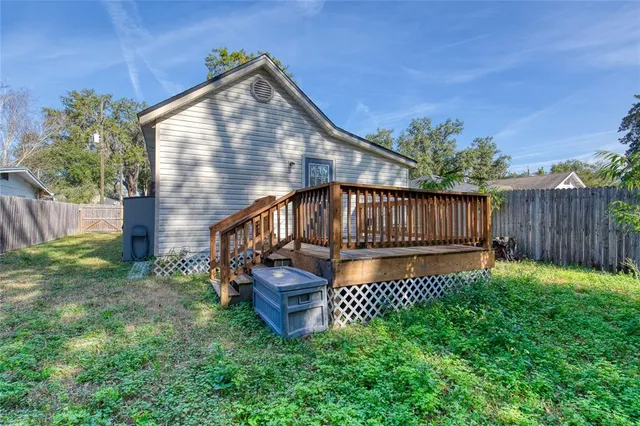 a view of backyard with deck and garden