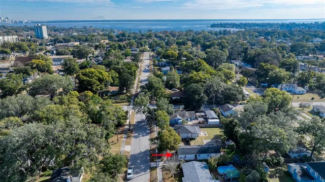 an aerial view of a houses with a yard