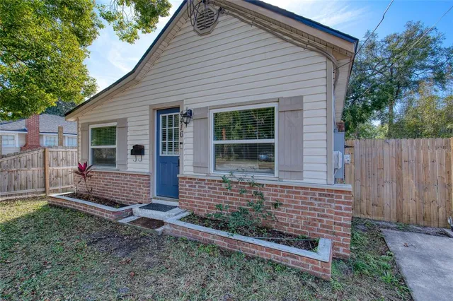 a view of house with backyard and wooden fence