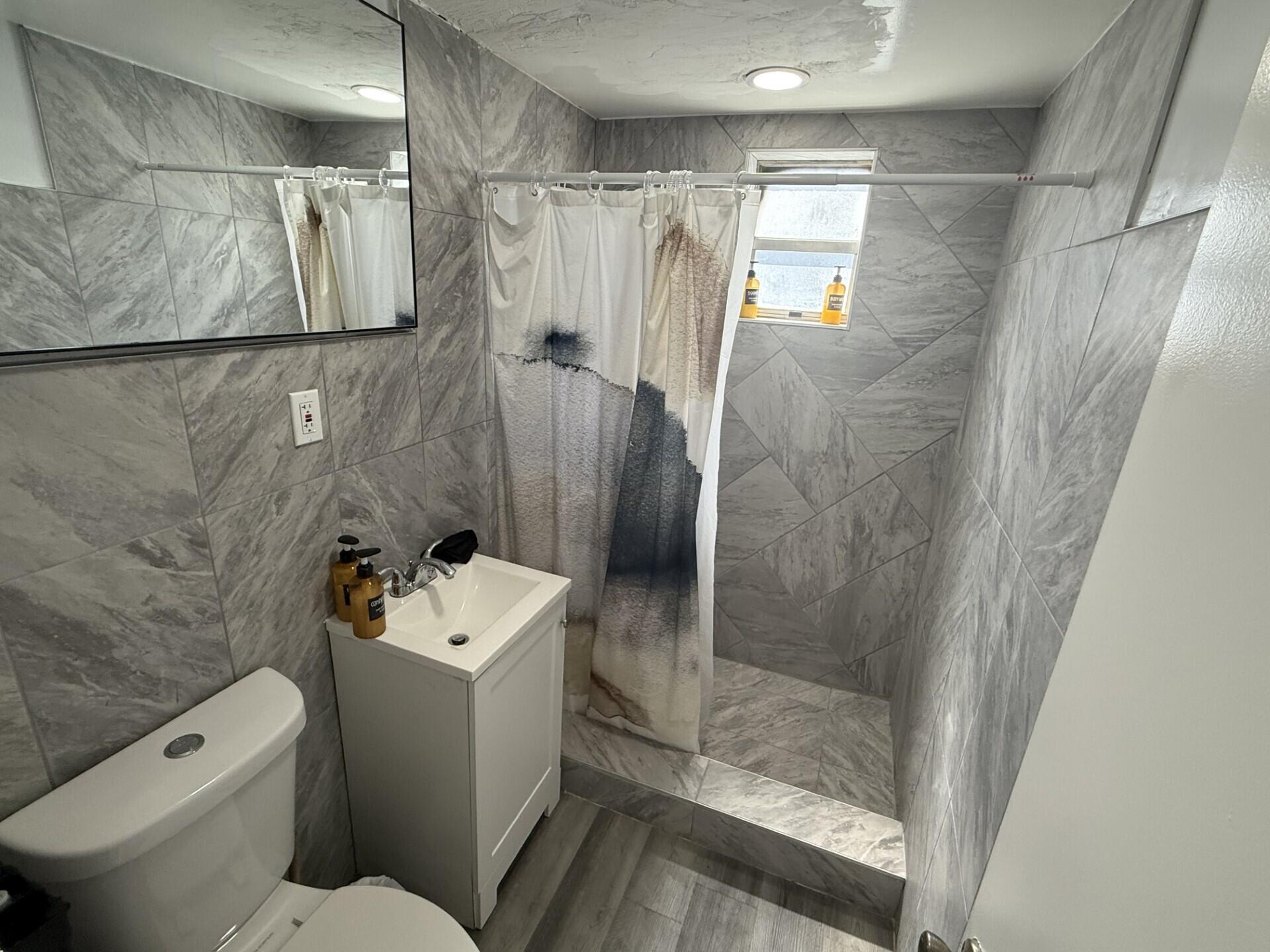 131 East 27th Street, Unit 6 Riviera Beach, FL 33404 - Photo 6 of 14 Downstairs bathroom
