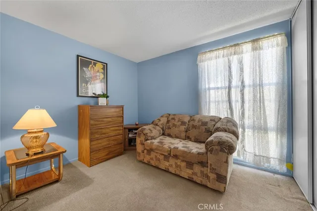 a bedroom with furniture and a window