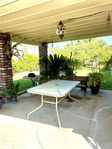 a view of a patio with a table and chairs and a table