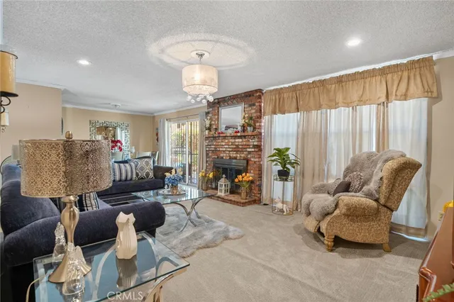 a living room with fireplace furniture and a chandelier