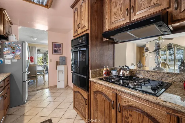 a kitchen with stainless steel appliances granite countertop a refrigerator and a stove