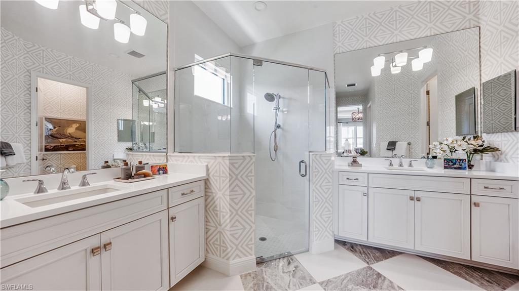 3992 Skysail Drive Naples, FL 34120 - Photo 12 of 12 a bathroom with a double vanity sink mirror and shower