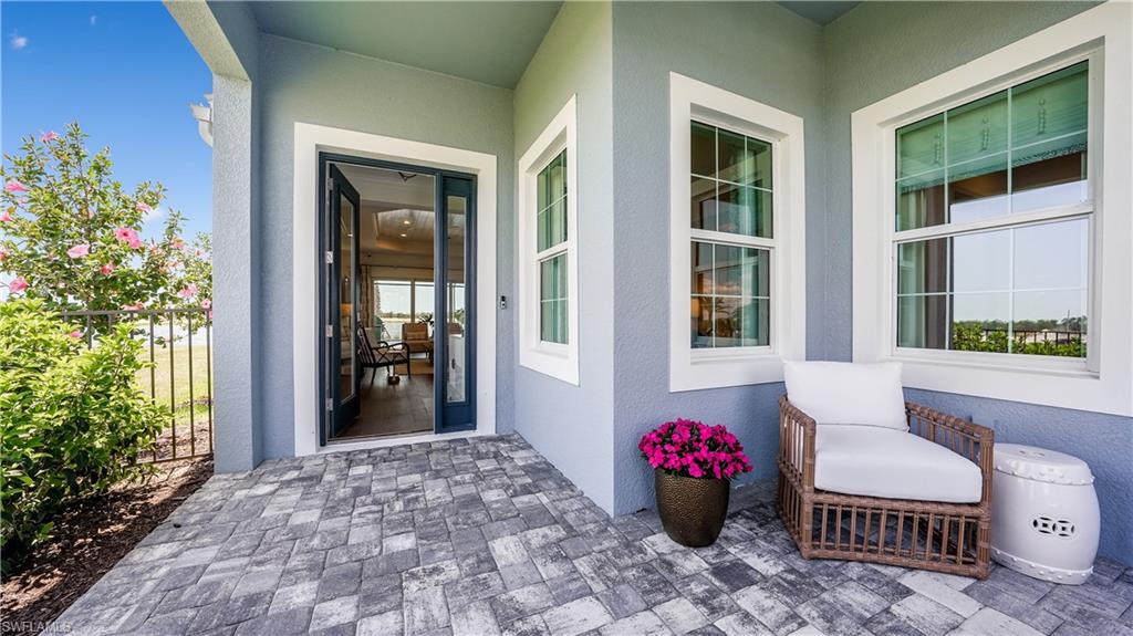 3992 Skysail Drive Naples, FL 34120 - Photo 2 of 12 a front view of a house with outdoor seating