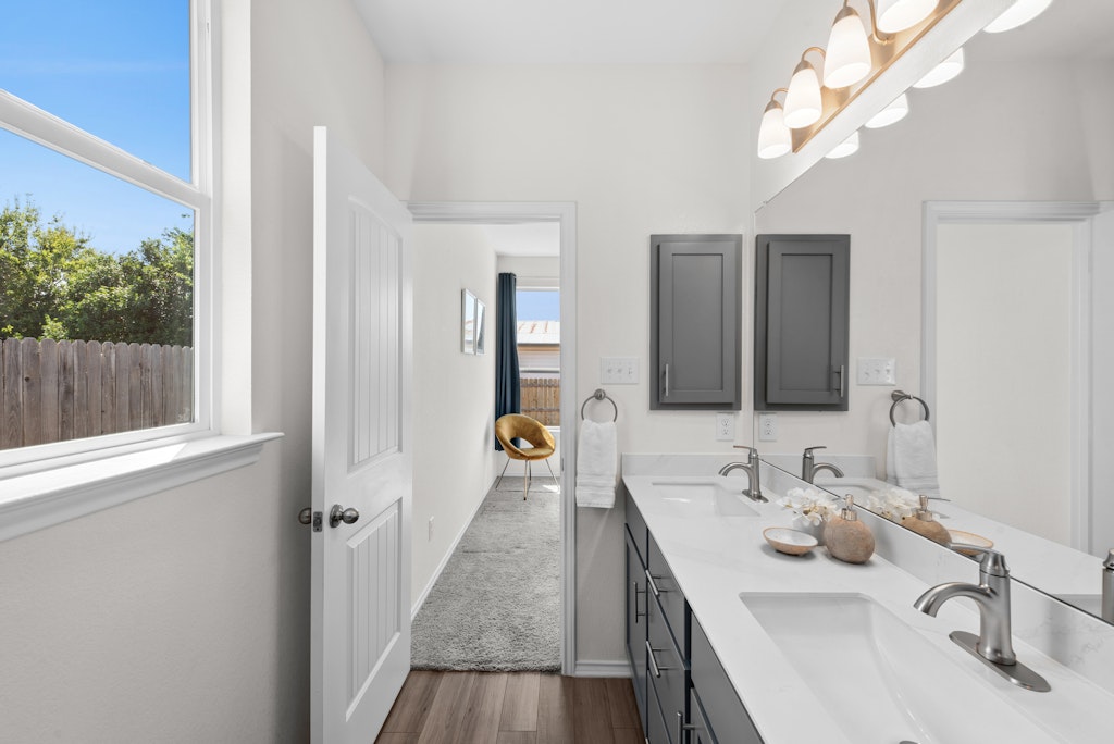 438 Thunder Valley Trail Georgetown, TX 78626 - Photo 11 of 21 a en suite bathroom with a double vanity sink and a mirror