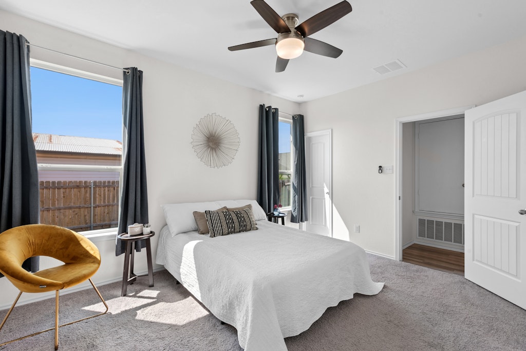 438 Thunder Valley Trail Georgetown, TX 78626 - Photo 7 of 21 a bedroom with a bed and dresser with wooden floor