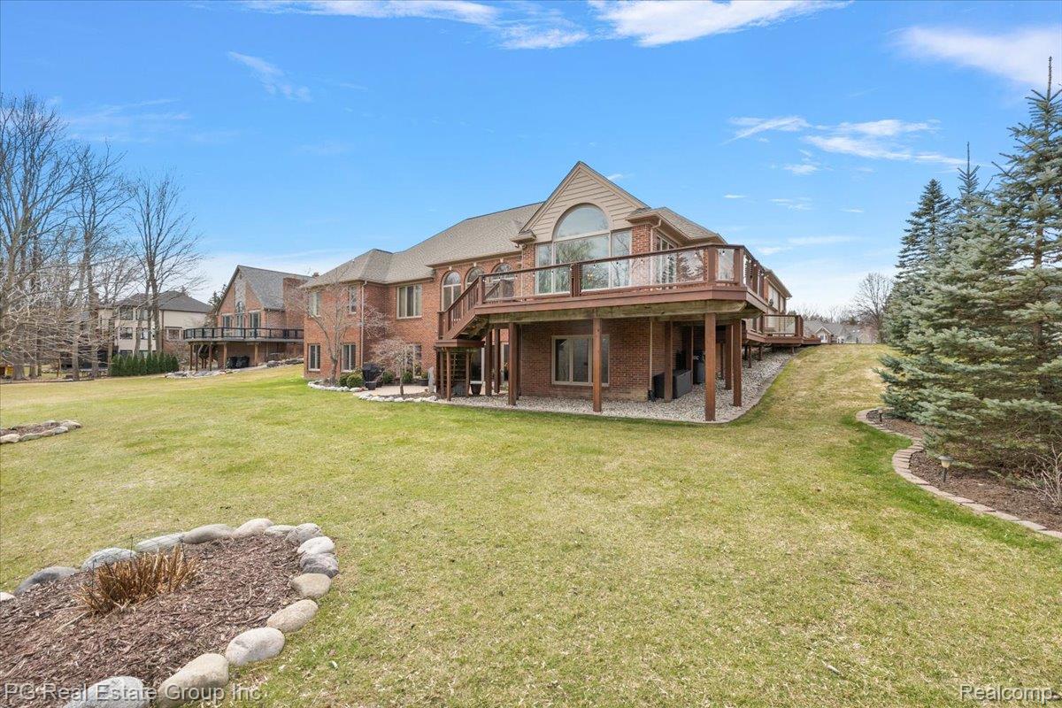 3571 Cedar Brook Drive Rochester, MI 48309 - Photo 10 of 57 Back of property featuring brick siding, a deck, a patio, and a yard