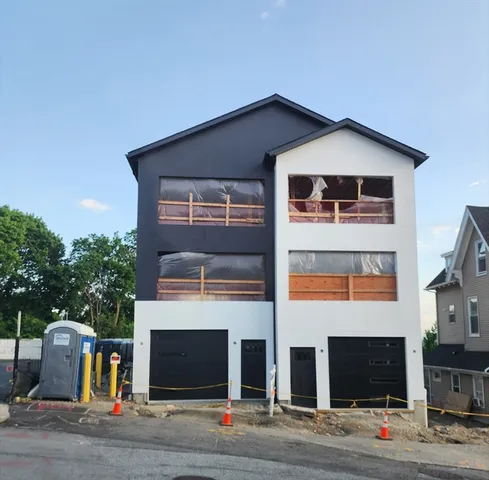 a front view of a house with garage