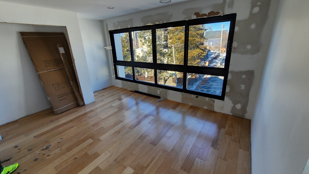 47 Laurel Street Worcester, MA 01605 - Photo 13 of 25 wooden floor in an empty room with a window