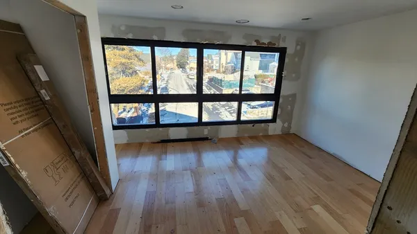 a view of a lobby with a couch and a fireplace
