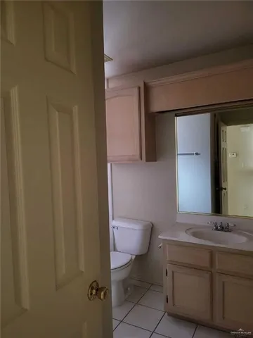 a bathroom with a sink a toilet a mirror and vanity