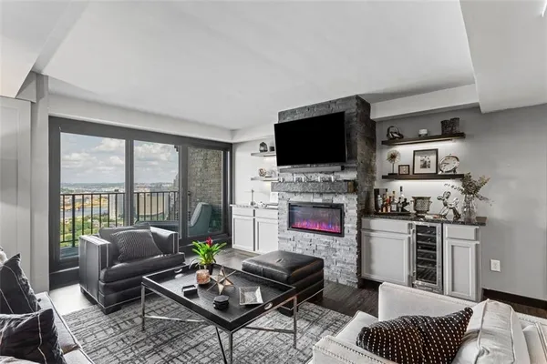 a living room with furniture a flat screen tv and a fireplace