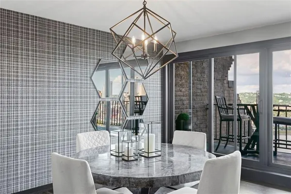 a view of a dining room with furniture wooden floor and chandelier