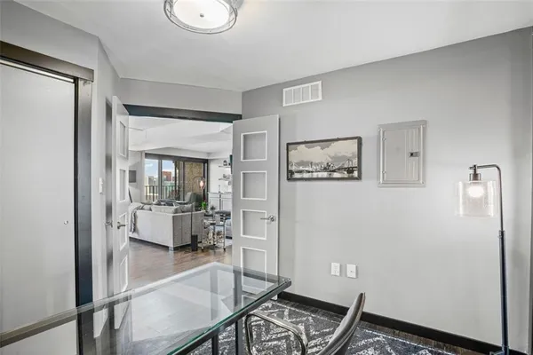 a view of a hallway with workspace and a couch