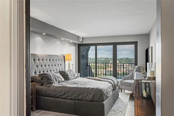 a bedroom with a bed and a large window