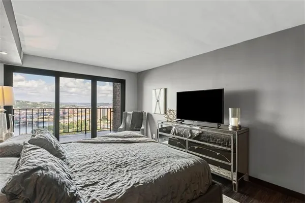 a bedroom with a bed and a flat screen tv