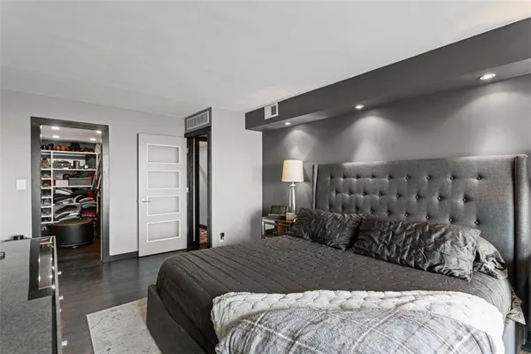 a bedroom with a large bed and a walk in closet
