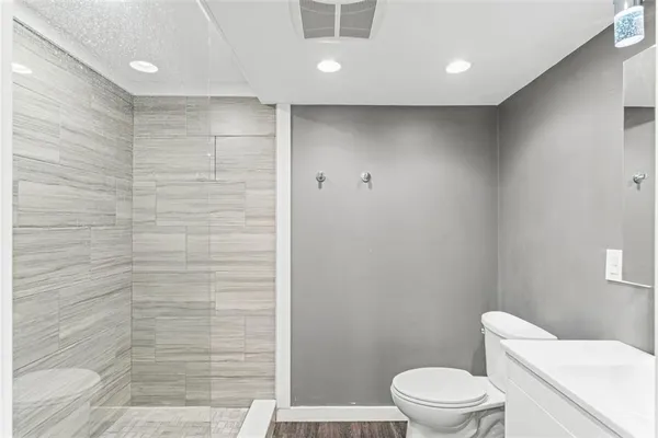 a bathroom with a toilet and a shower