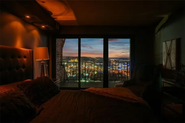 a bed sitting in a bedroom next to a window