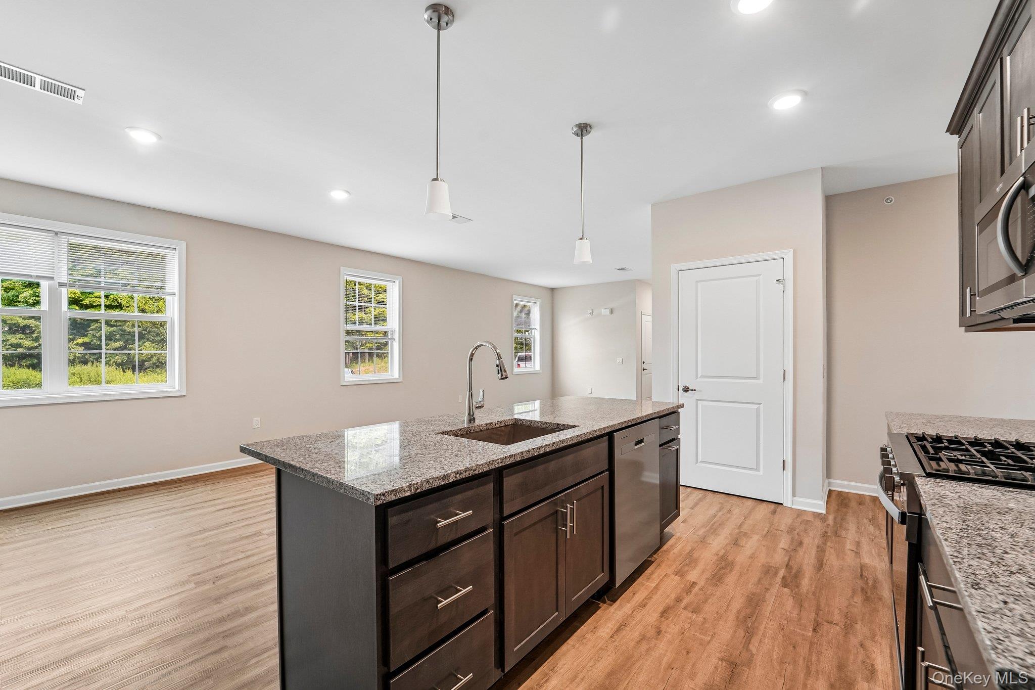 Kitchen island with a built-in sink and stainless steel appliances