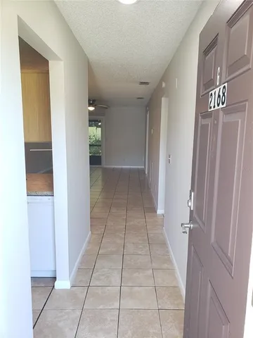 a view of a hallway to rooms and stairs