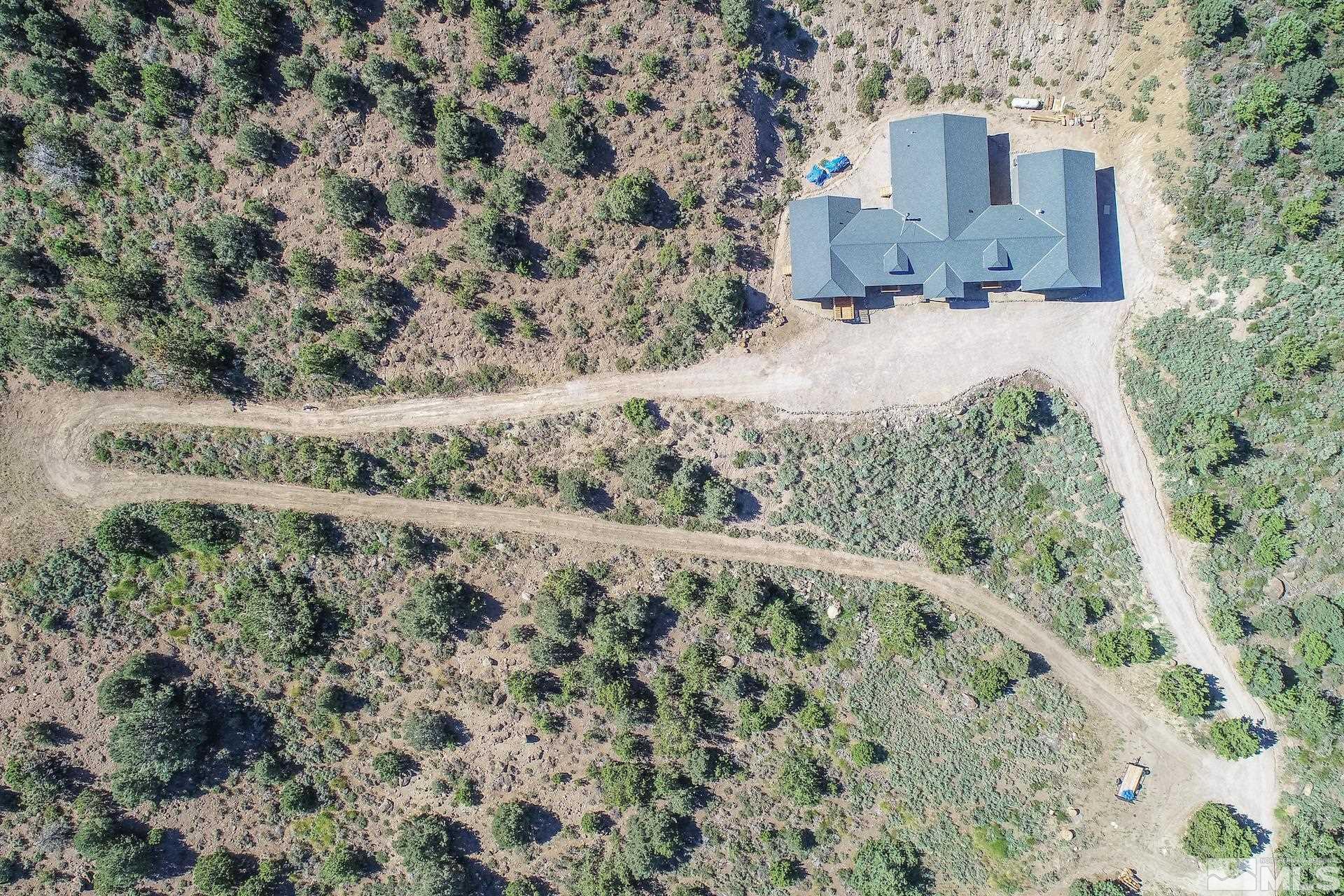 4600 Tybo Road Reno, NV 89521 - Photo 36 of 40 a view of a wooden house with a yard and large tree
