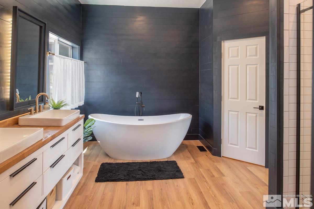 4600 Tybo Road Reno, NV 89521 - Photo 4 of 40 a spacious bathroom with a granite countertop sink and a mirror