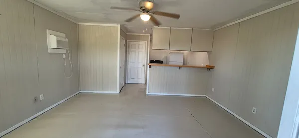 a view of empty room with ceiling fan