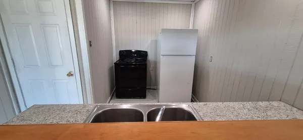 a kitchen with a refrigerator and cabinets