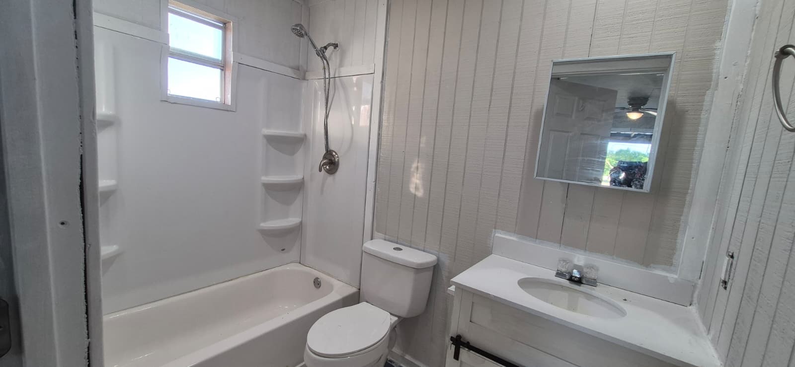 18530 Brumbelow Road Needville, TX 77461 - Photo 5 of 7 Inviting full bathroom with a shower-tub combo, efficient storage, and bright natural light.