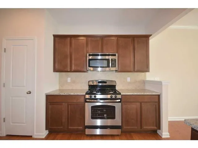 a kitchen with a stove and a microwave