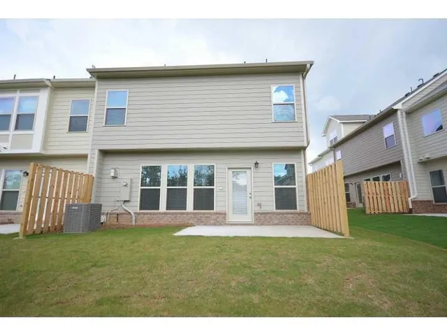 a view of a house with backyard and porch