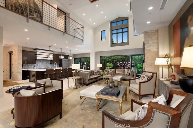 a living room with fireplace furniture and a potted plant