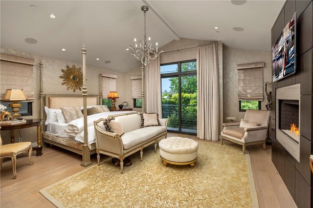 a living room with furniture chandelier and a fireplace