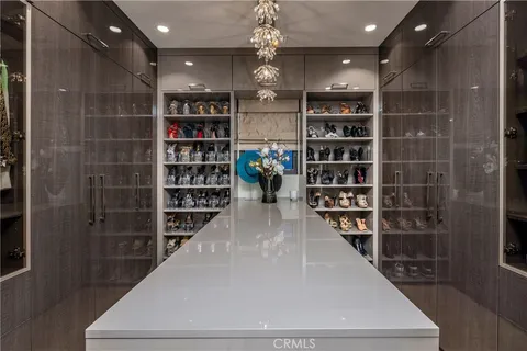 a view of a hallway with wooden shelves