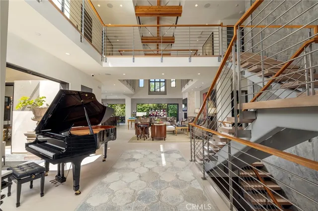a living room with lots of furniture and a piano
