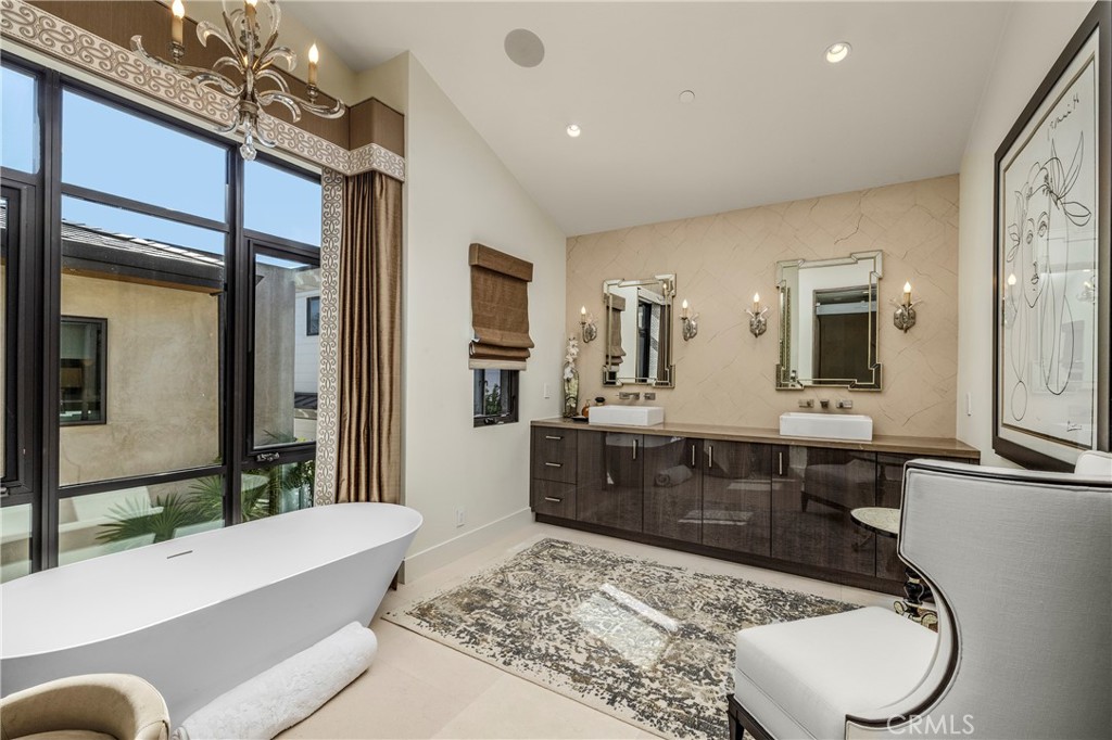 401 Snug Harbor Road Newport Beach, CA 92663 - Photo 21 of 35 a bathroom with a tub a sink and a large mirror